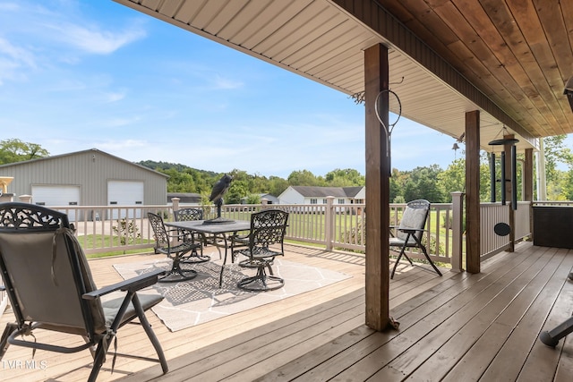 wooden terrace with an outbuilding and a garage