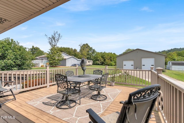 wooden deck with an outbuilding and a garage