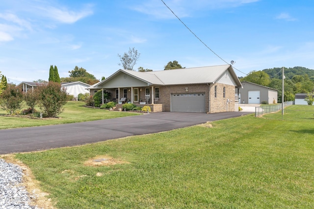 ranch-style house featuring a garage, covered porch, and a front yard