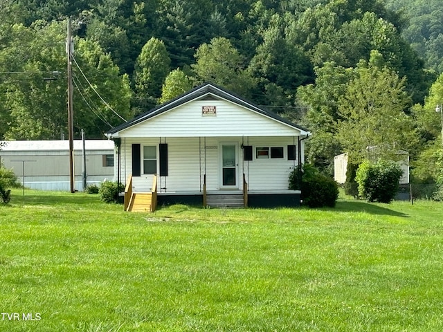 view of front of property with covered porch and a front lawn