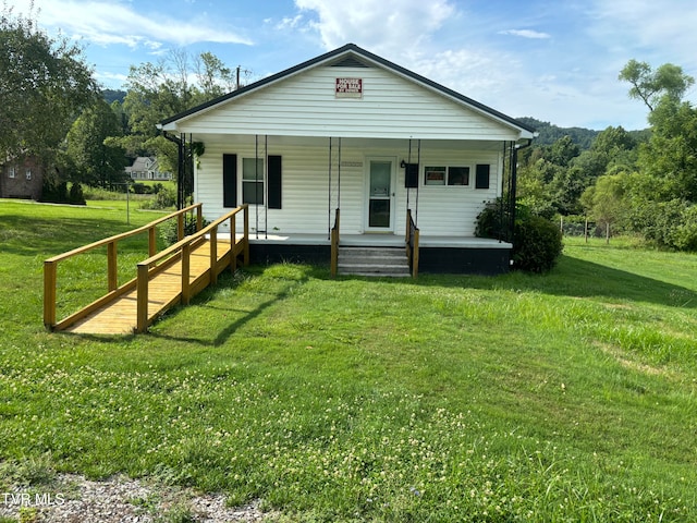 bungalow with a porch and a front lawn