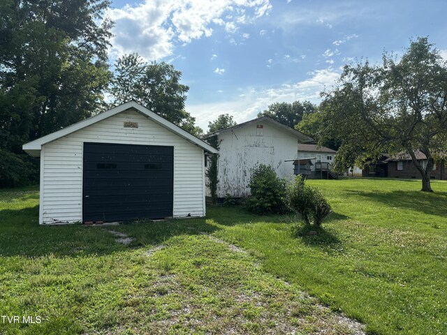 garage featuring a lawn