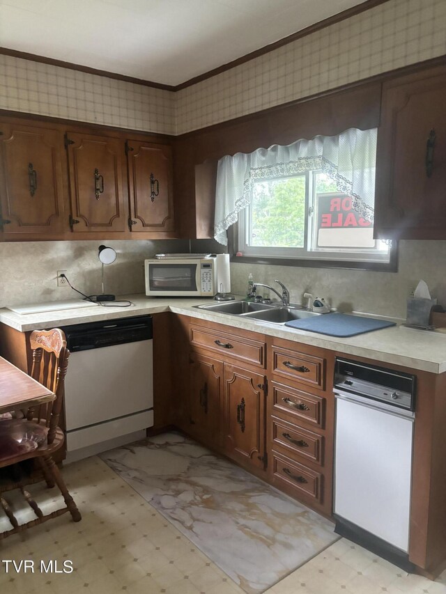 kitchen with crown molding, white appliances, sink, and decorative backsplash