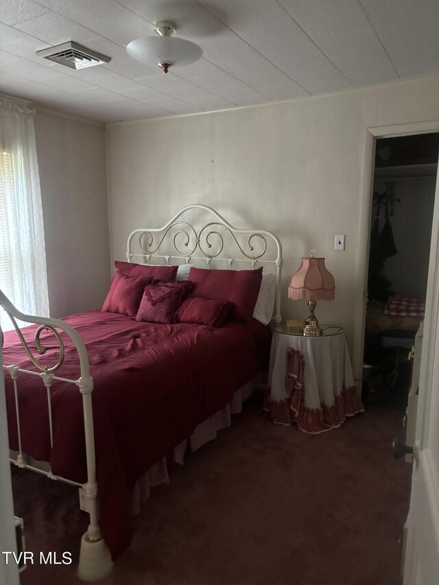 bedroom featuring dark carpet