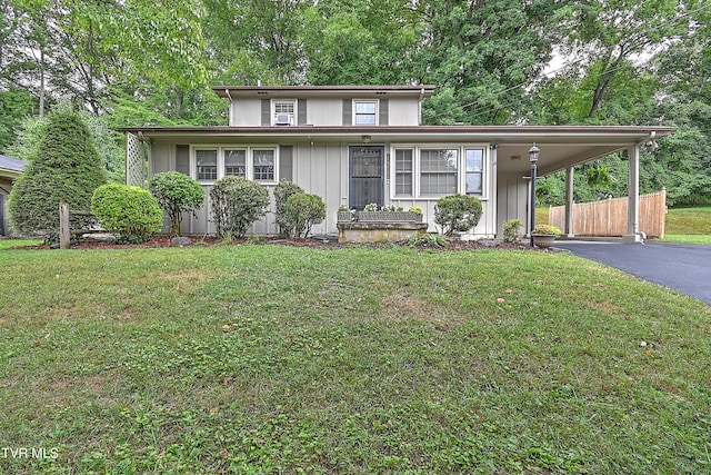 view of front facade with a front lawn and a carport