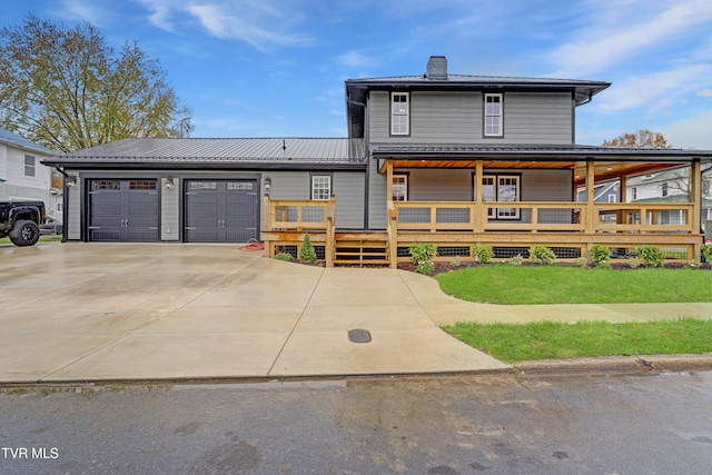 view of front facade with a wooden deck and a garage