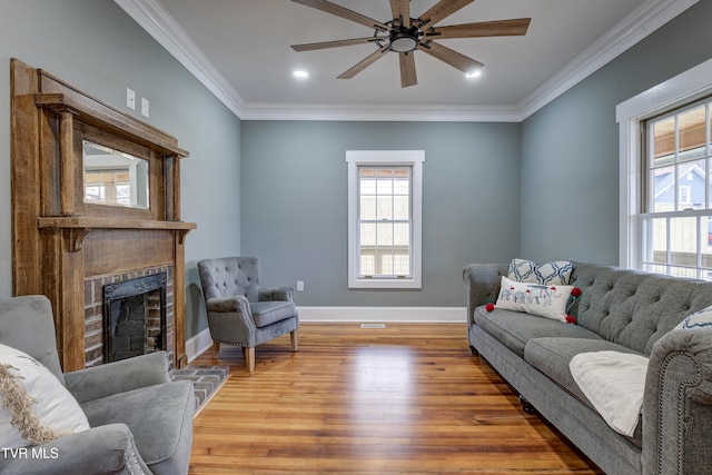 living room with ceiling fan, wood-type flooring, and crown molding