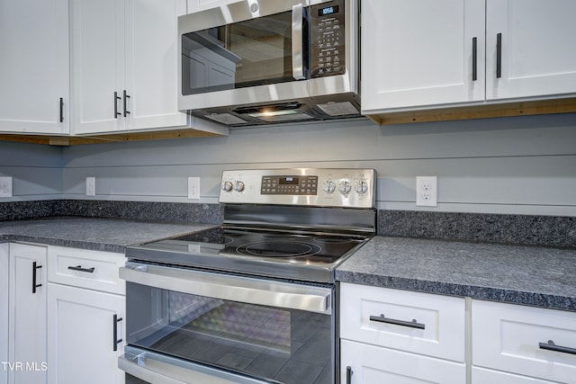 kitchen featuring stainless steel appliances and white cabinetry