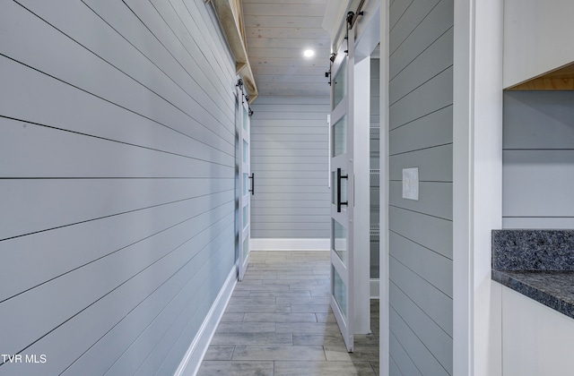 corridor featuring a barn door