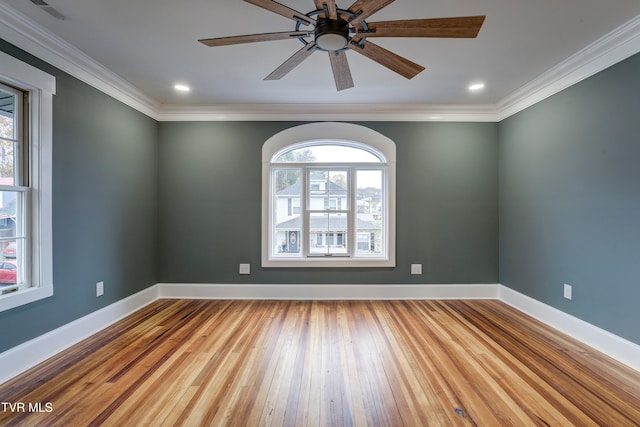 empty room with crown molding, light hardwood / wood-style flooring, and a healthy amount of sunlight