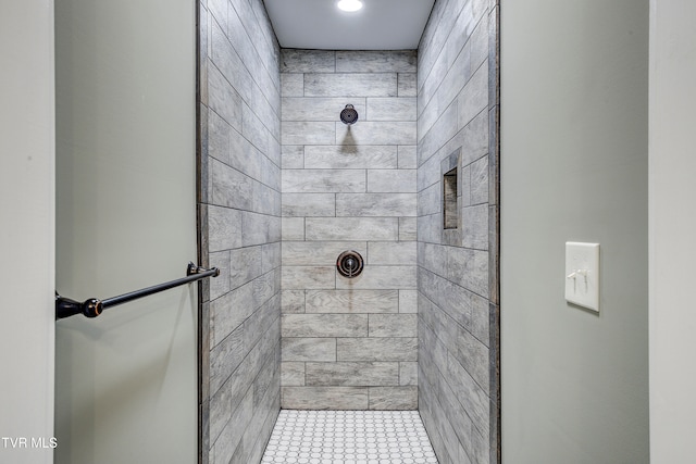 bathroom with a tile shower