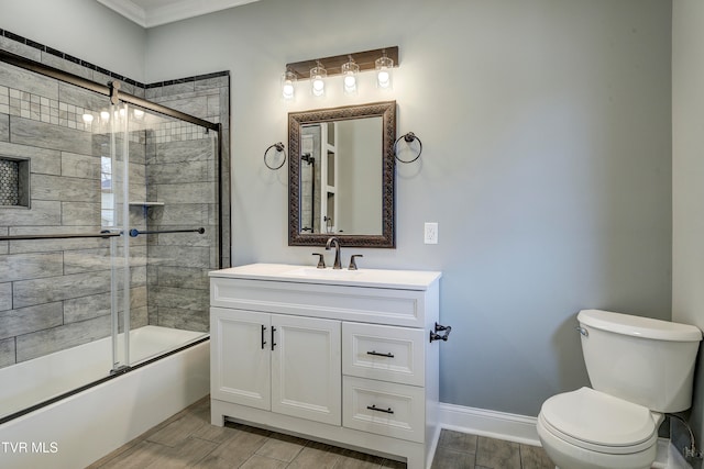 full bathroom featuring vanity, toilet, crown molding, and enclosed tub / shower combo