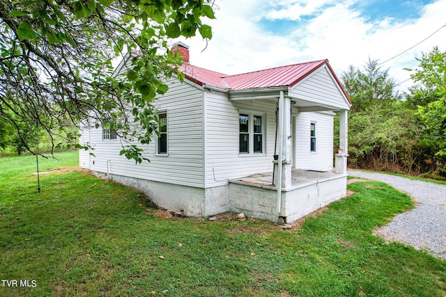 view of side of home featuring a yard