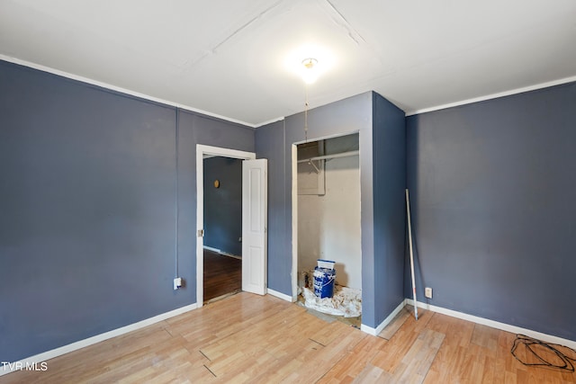 unfurnished bedroom featuring light hardwood / wood-style flooring and a closet