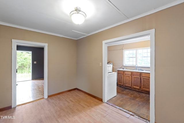 empty room featuring ornamental molding, light hardwood / wood-style flooring, and a wealth of natural light