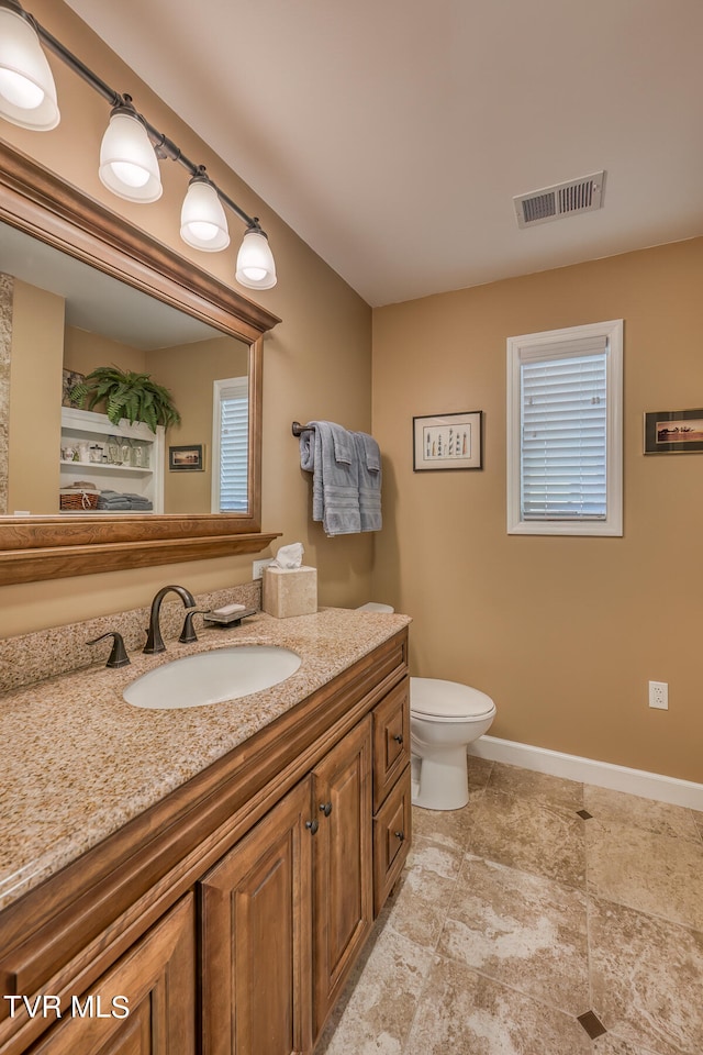 bathroom with vanity, tile patterned floors, and toilet