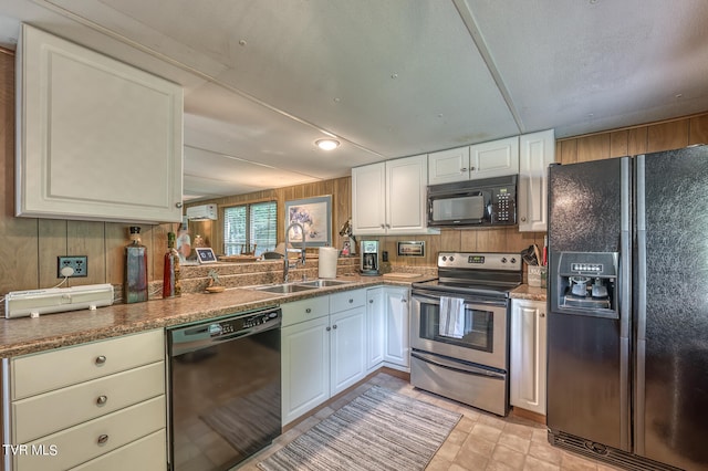 kitchen featuring light tile patterned flooring, sink, white cabinetry, and black appliances