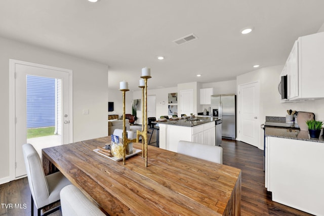 dining room with sink and dark hardwood / wood-style floors