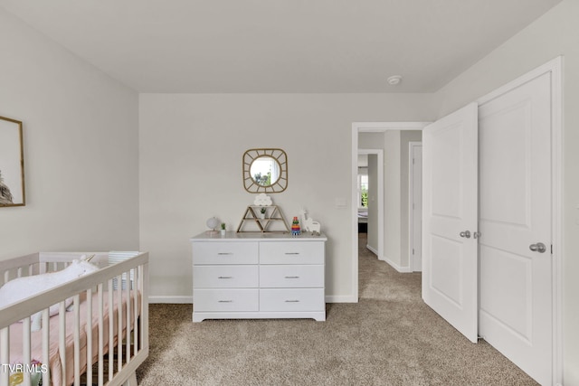 carpeted bedroom with a crib