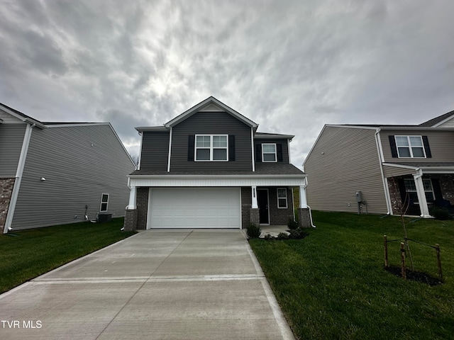 view of front of home featuring a front yard and a garage