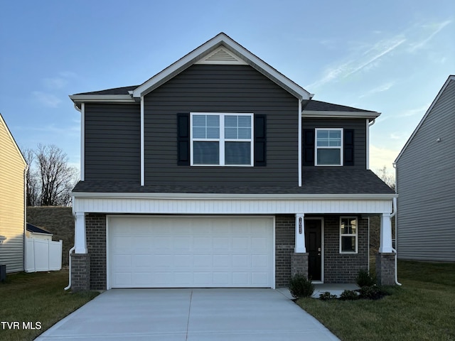 view of front of home with a front lawn and a garage