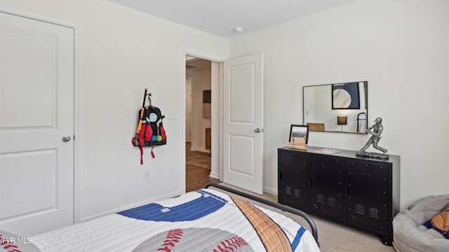 bedroom featuring light carpet