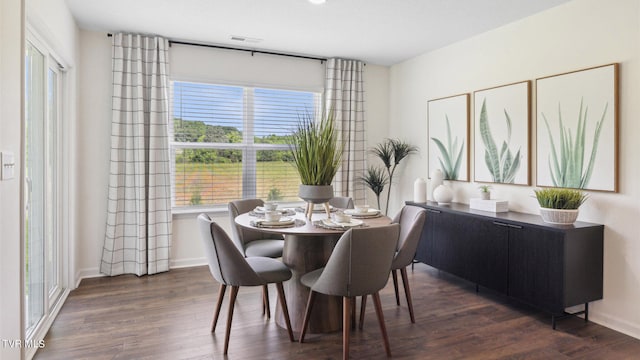 dining space with dark wood-type flooring