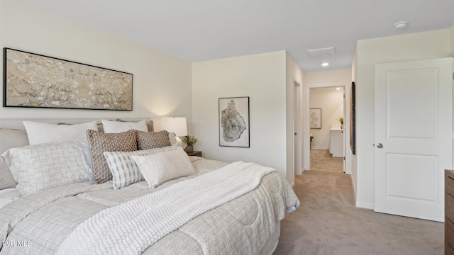 bedroom featuring light carpet