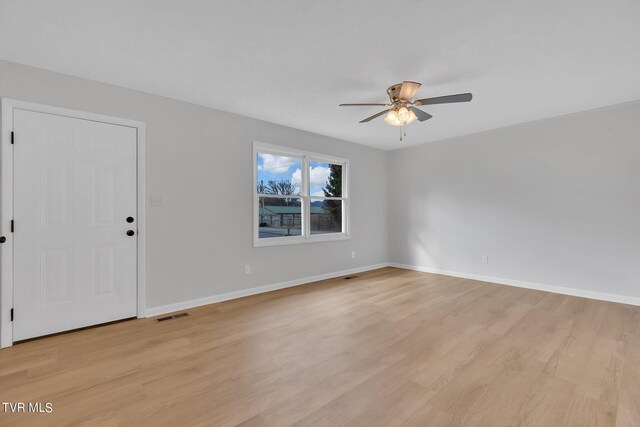 spare room featuring light wood-type flooring and ceiling fan