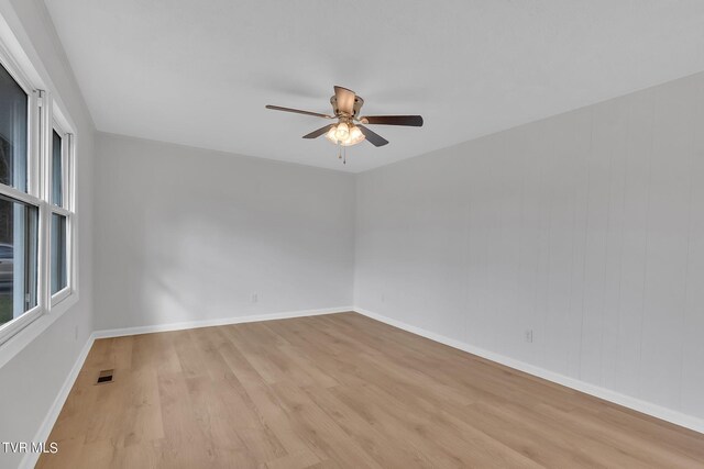 empty room with light wood-type flooring and ceiling fan