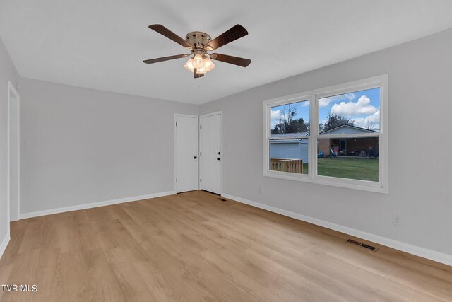 unfurnished room featuring ceiling fan and light wood-type flooring