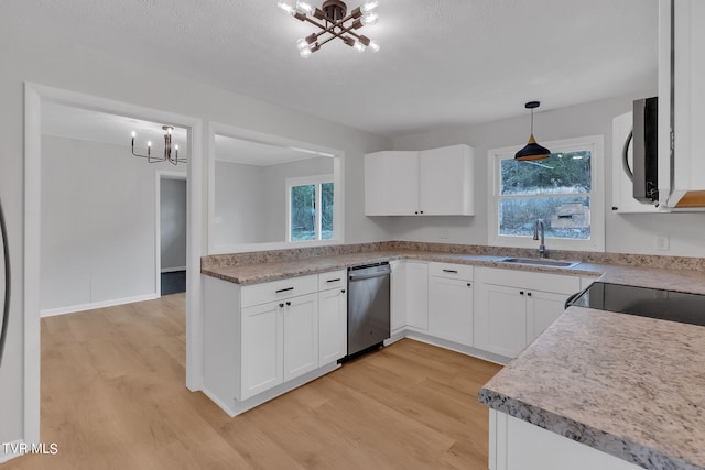 kitchen with a chandelier, stainless steel appliances, white cabinets, light wood-type flooring, and sink