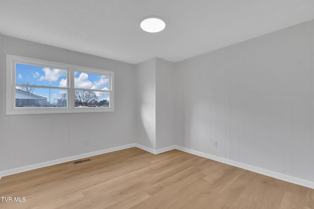 unfurnished room with light hardwood / wood-style flooring