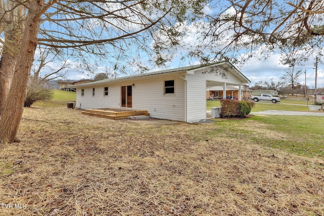 rear view of property with a yard