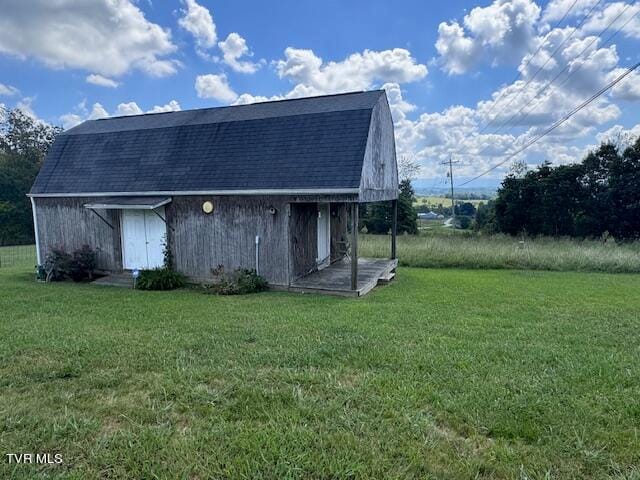 view of outbuilding featuring a lawn