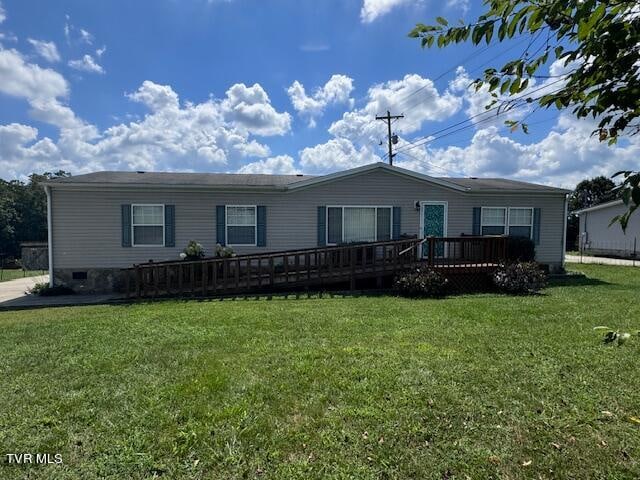 view of front of home featuring a deck and a front lawn