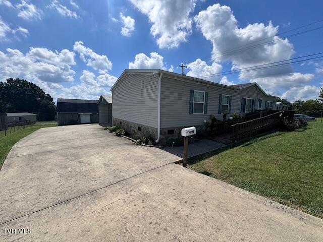 view of side of property with a yard