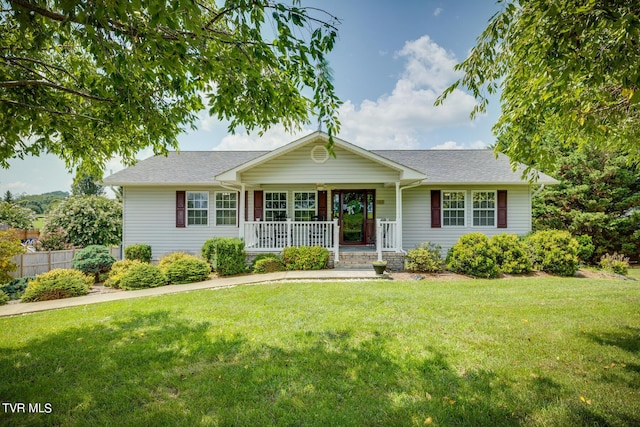 single story home featuring covered porch and a front yard