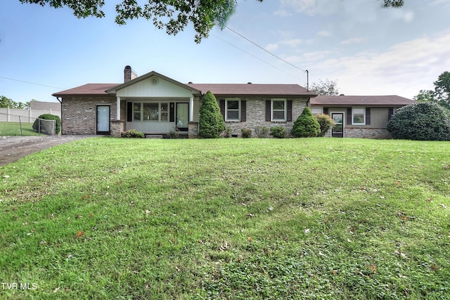 ranch-style home featuring a front yard