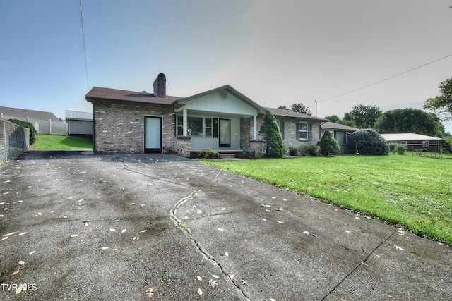 ranch-style home with a front lawn