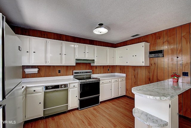 kitchen with wood walls, light hardwood / wood-style flooring, kitchen peninsula, white fridge, and electric stove