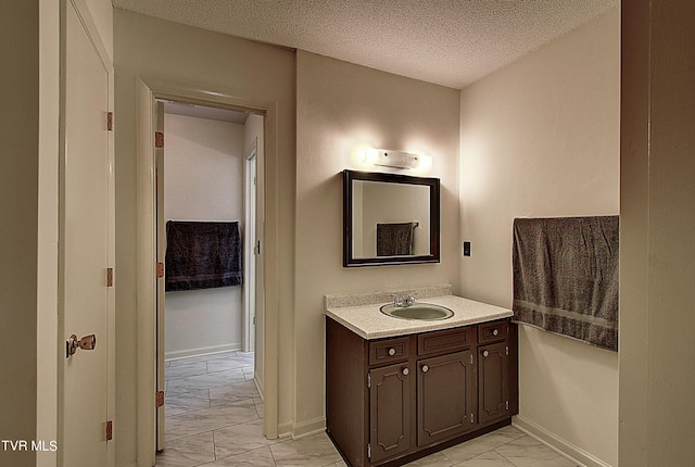 bathroom featuring vanity and a textured ceiling