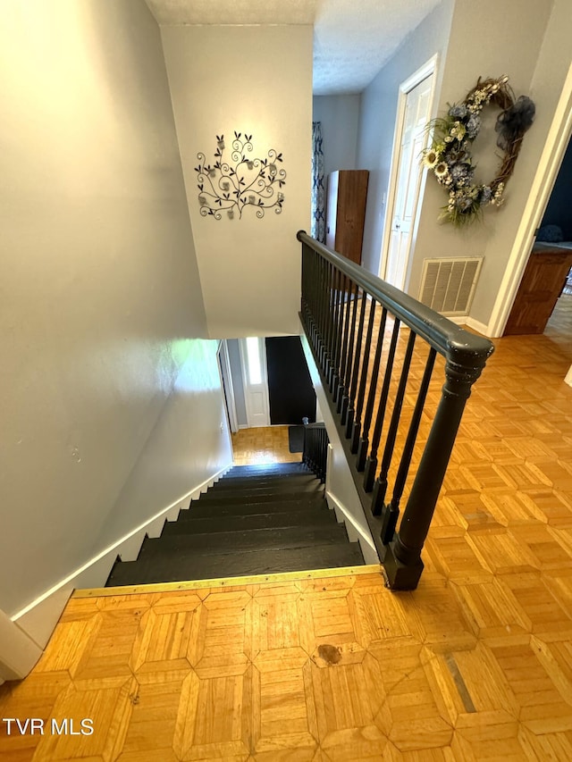 stairs with parquet flooring