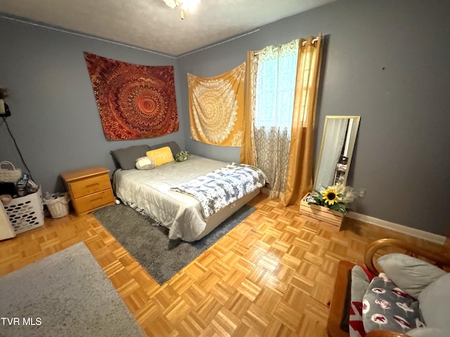 bedroom featuring parquet flooring