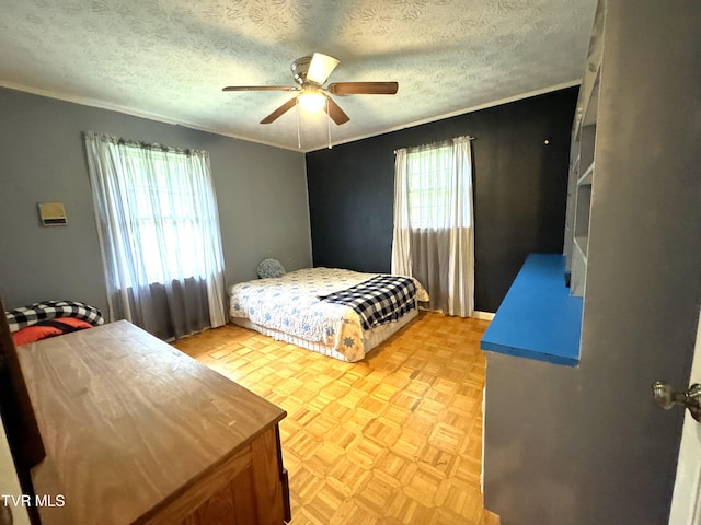 bedroom with light parquet flooring, crown molding, ceiling fan, and a textured ceiling