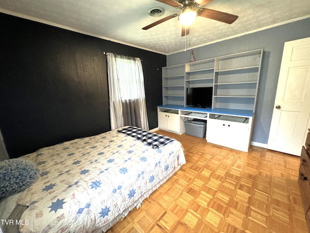 bedroom with light parquet floors, ornamental molding, ceiling fan, and a textured ceiling