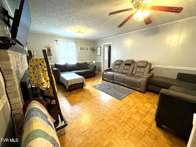 living room featuring light parquet floors, crown molding, a brick fireplace, and a textured ceiling