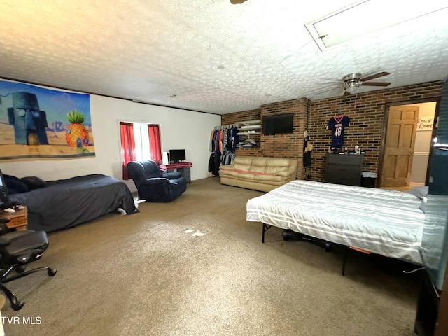 carpeted bedroom with brick wall and a textured ceiling