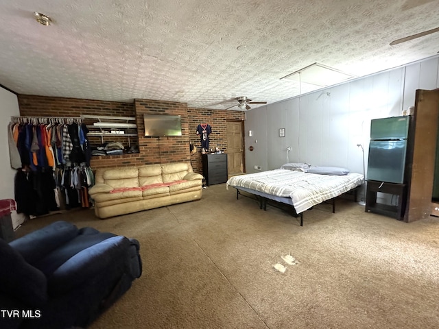 bedroom with brick wall, carpet, and a textured ceiling