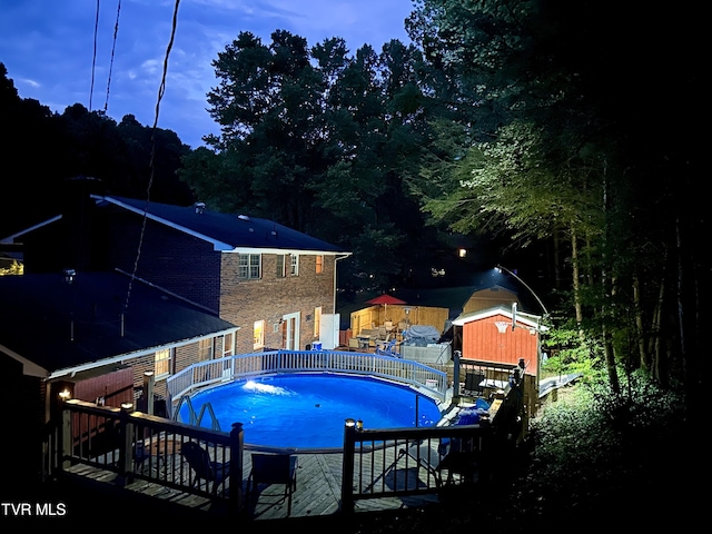 view of pool at dusk